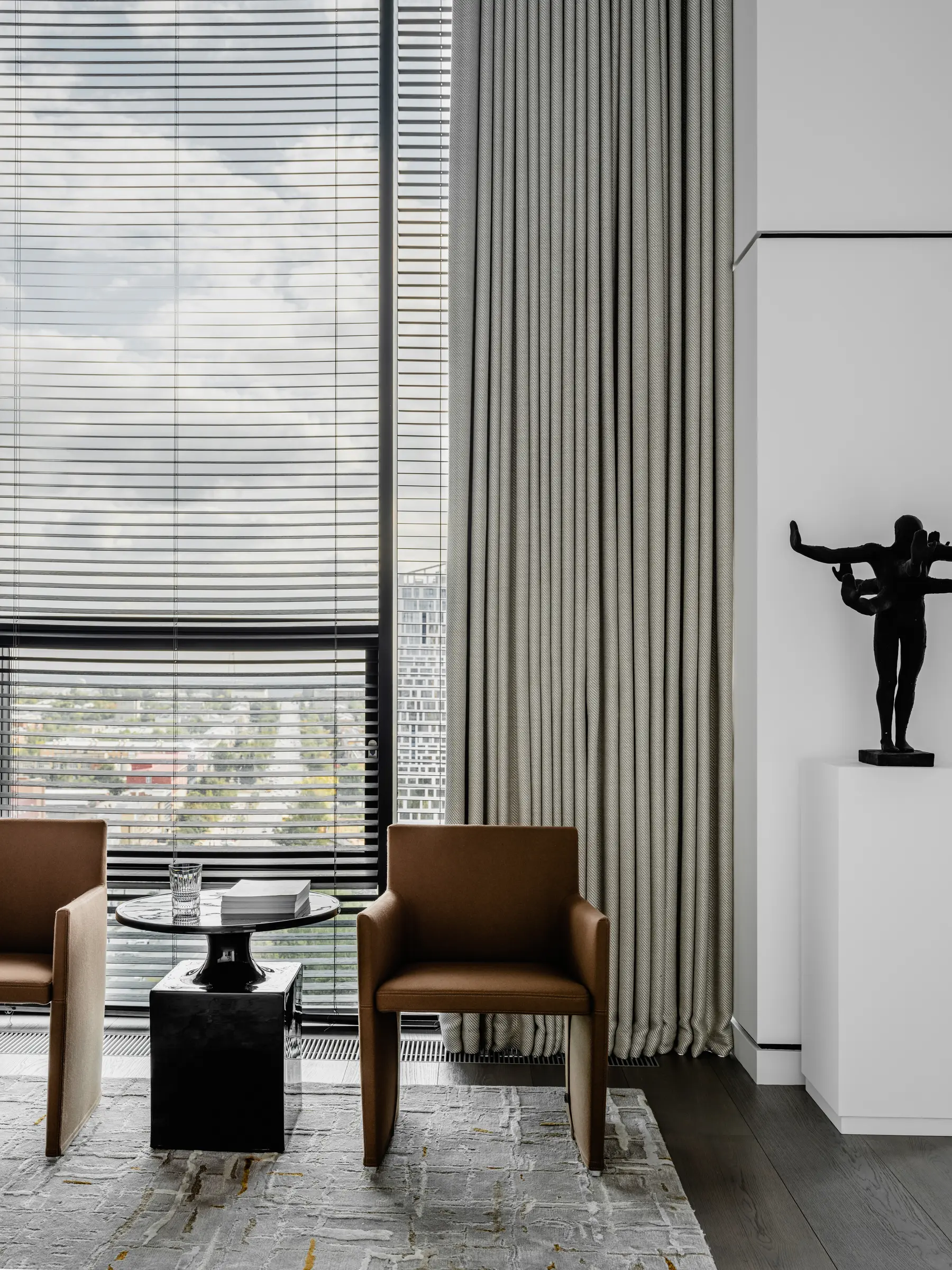Armchairs and sculpture by the window